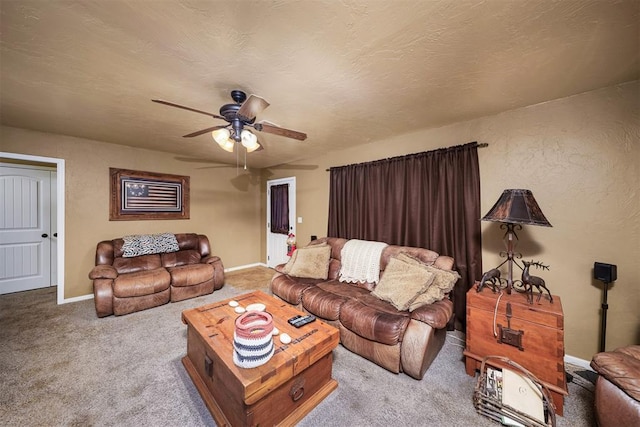 living room with light carpet, ceiling fan, and a textured ceiling