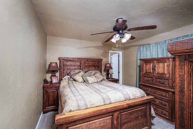 bedroom featuring ceiling fan, light colored carpet, and a textured ceiling