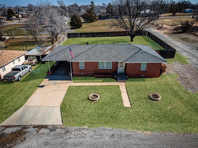 404 N Bryan Ave, Mangum, OK 73554 - view of front of house with concrete driveway, a shingled roof, brick siding, and an attached carport