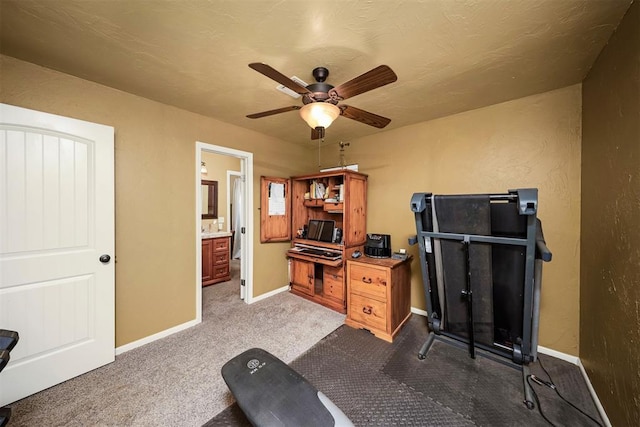 404 N Bryan Ave, Mangum, OK 73554 - exercise room featuring ceiling fan and dark colored carpet