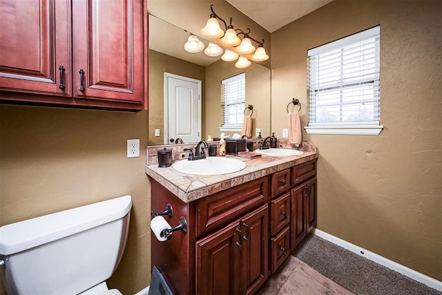 404 N Bryan Ave, Mangum, OK 73554 - bathroom featuring double vanity and a textured wall
