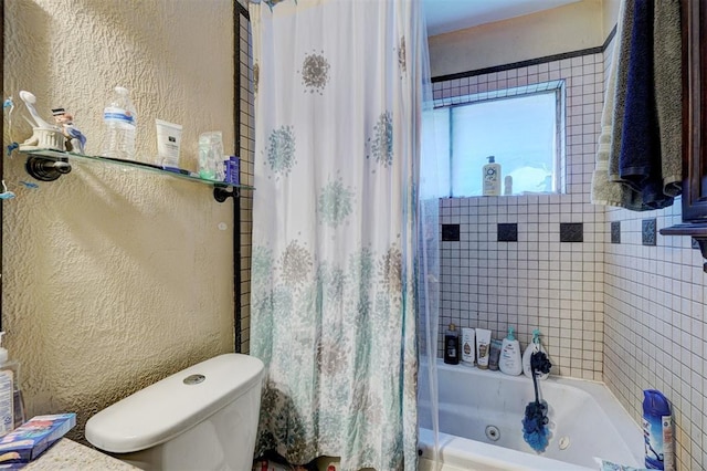 full bathroom with toilet, shower / bath combo, and a textured wall