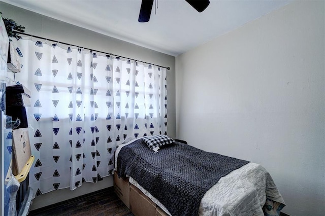 bedroom featuring ceiling fan and dark wood-style flooring