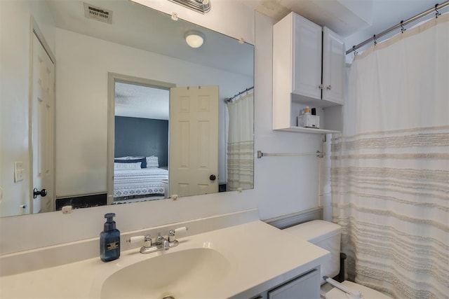 bathroom with vanity and toilet