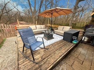 wooden terrace with outdoor lounge area and fence
