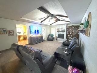 cinema featuring carpet flooring, a fireplace, and a ceiling fan