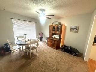 dining area with a textured ceiling and a ceiling fan