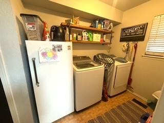 laundry area with washer and clothes dryer and laundry area