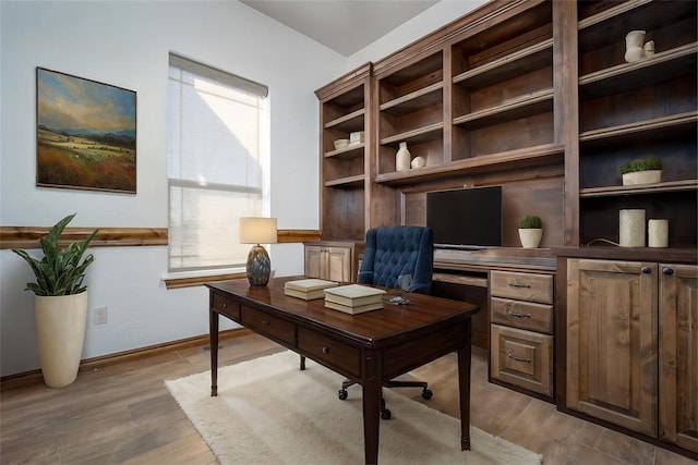 office with light wood-style flooring and baseboards