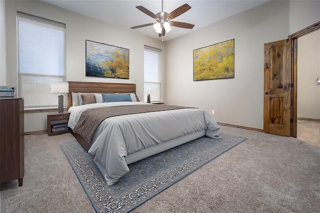 bedroom with light carpet, ceiling fan, and baseboards