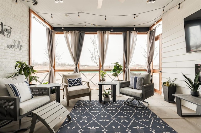 sunroom / solarium featuring rail lighting