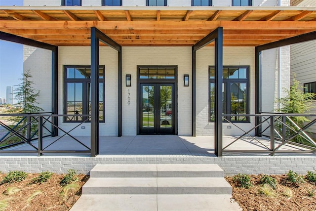 doorway to property with brick siding