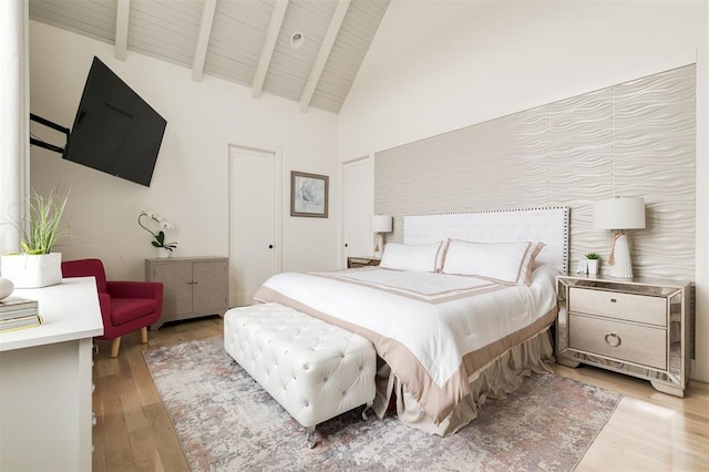 bedroom with wood ceiling, high vaulted ceiling, beam ceiling, and light wood-style floors