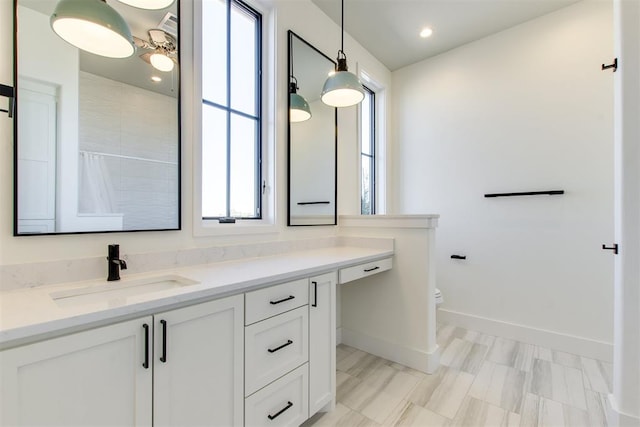 full bathroom with recessed lighting, toilet, vanity, and baseboards