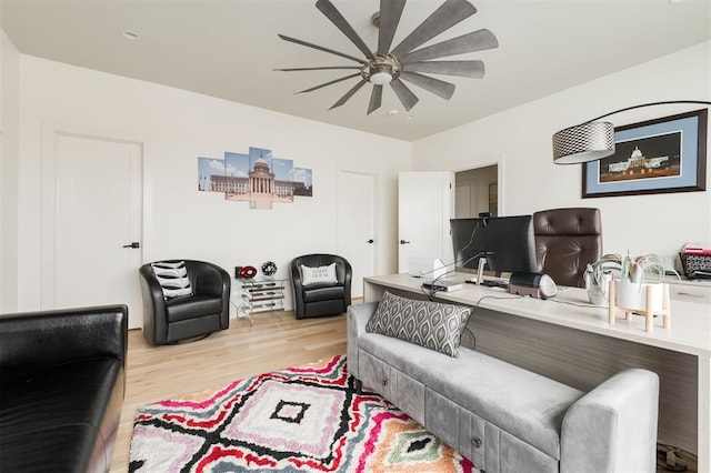 living area featuring light wood finished floors and a ceiling fan