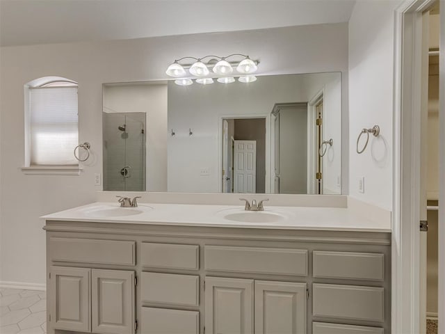 bathroom with tile patterned flooring, vanity, and a shower with shower door