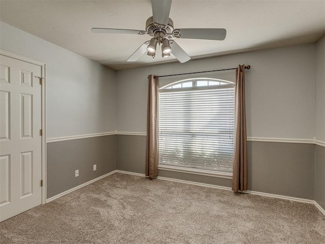 carpeted empty room featuring ceiling fan