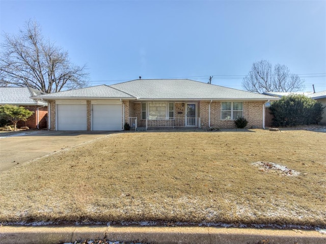 ranch-style home featuring a garage, a front lawn, and a porch