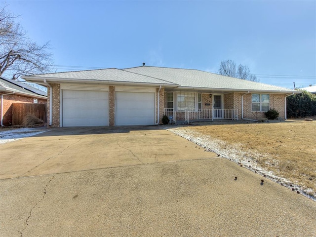 single story home with a garage and covered porch