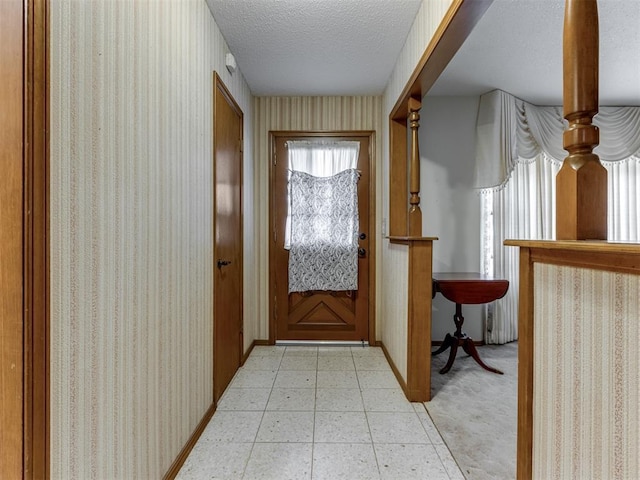 7000 N Libby Ave, Oklahoma City, OK 73132 - doorway to outside featuring light tile patterned floors and a textured ceiling