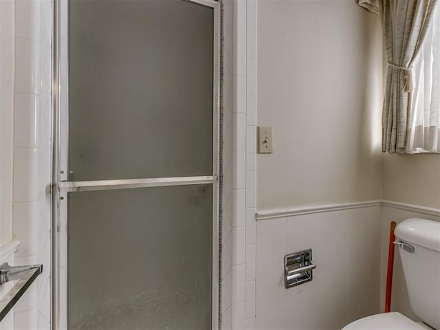 7000 N Libby Ave, Oklahoma City, OK 73132 - bathroom featuring toilet and a shower with shower door