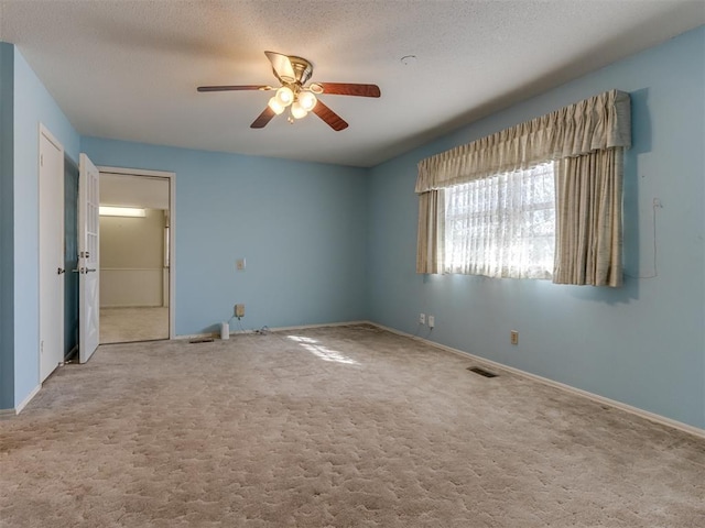 7000 N Libby Ave, Oklahoma City, OK 73132 - unfurnished bedroom with ceiling fan, carpet floors, and a textured ceiling