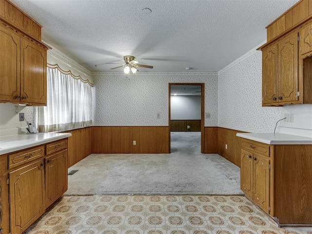 7000 N Libby Ave, Oklahoma City, OK 73132 - kitchen with ceiling fan, light colored carpet, ornamental molding, and a textured ceiling