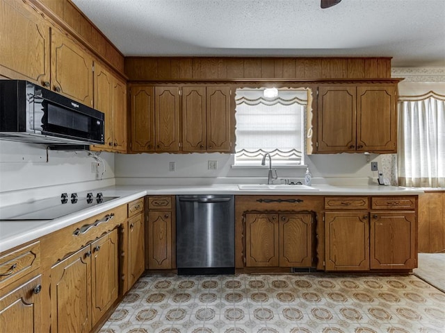 7000 N Libby Ave, Oklahoma City, OK 73132 - kitchen featuring sink, a textured ceiling, and black appliances