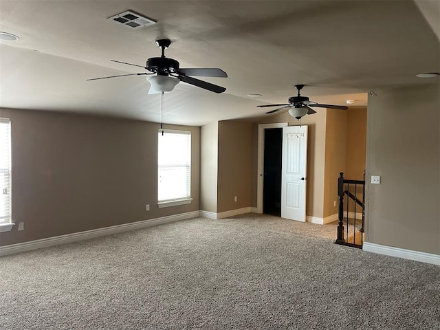 empty room featuring carpet and vaulted ceiling