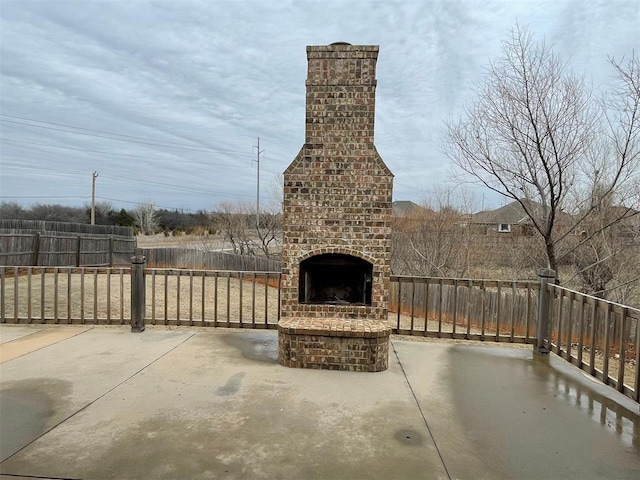 view of patio with an outdoor brick fireplace