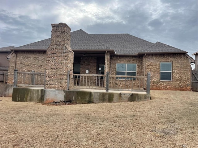 back of house with a lawn