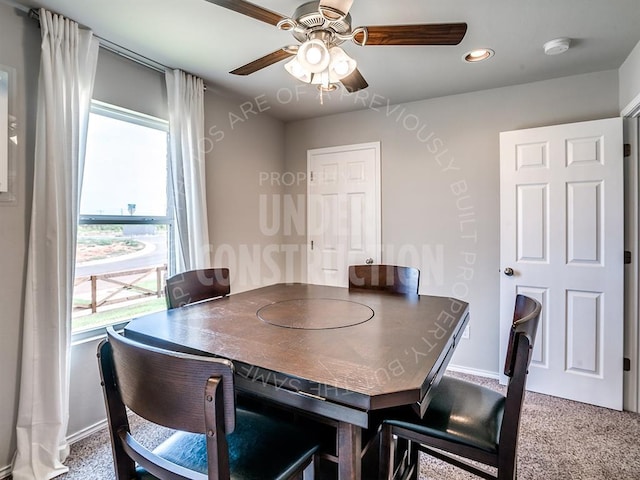 dining area featuring ceiling fan and carpet flooring