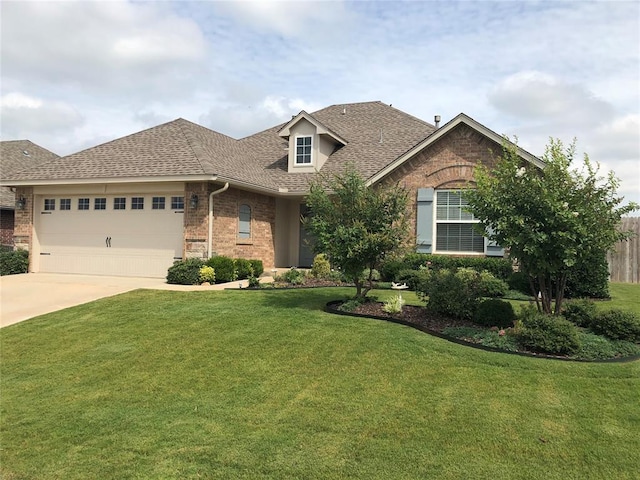 view of front of property featuring a garage and a front yard