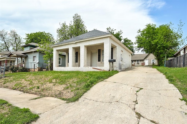 1315 NW 7th St, Oklahoma City, OK 73106 - view of front of property with fence, driveway, and brick siding