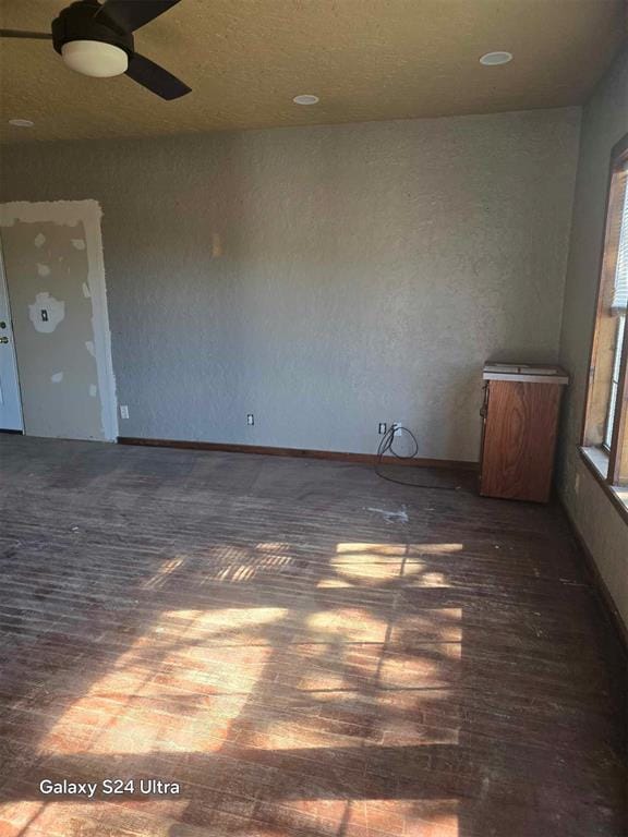 unfurnished room featuring dark hardwood / wood-style flooring and ceiling fan