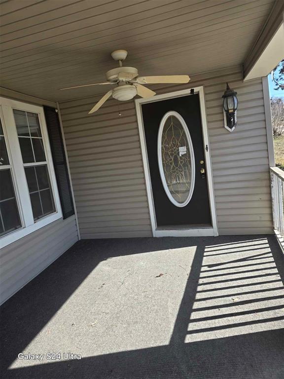 entrance to property featuring ceiling fan