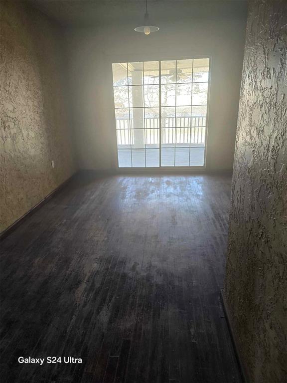 empty room with dark hardwood / wood-style floors