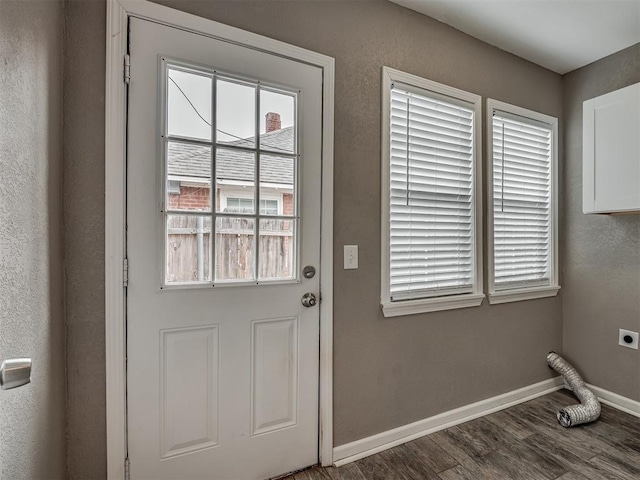 doorway to outside featuring wood finished floors and baseboards