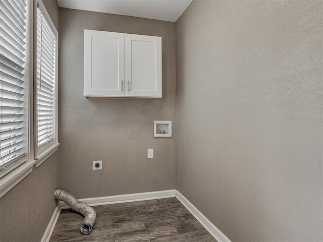 laundry area with dark wood-style floors, baseboards, hookup for an electric dryer, cabinet space, and washer hookup