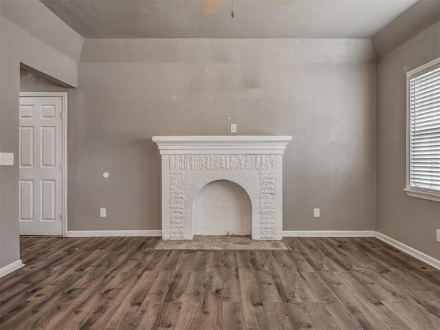 unfurnished living room with wood finished floors and baseboards