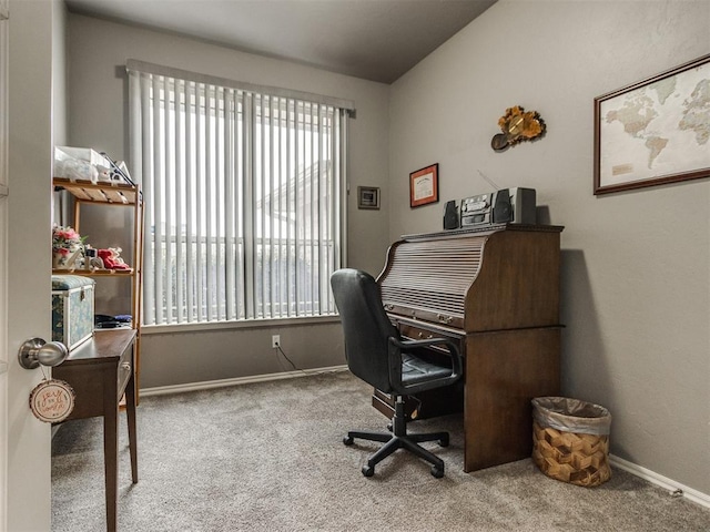 carpeted office space featuring baseboards