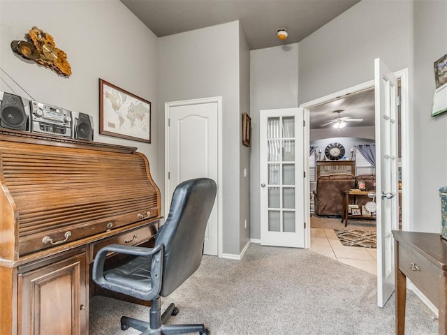 office area with light tile patterned floors, french doors, baseboards, and light colored carpet