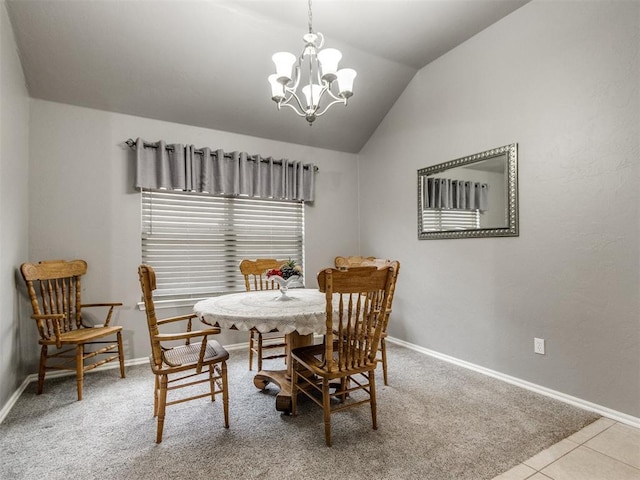 carpeted dining space with lofted ceiling, baseboards, a notable chandelier, and tile patterned floors