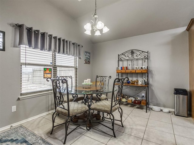 dining room featuring light tile patterned floors, baseboards, a chandelier, and vaulted ceiling