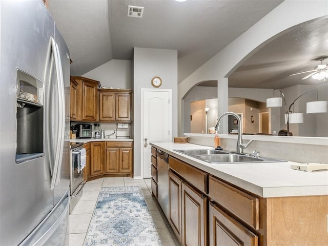 kitchen with light tile patterned flooring, a sink, visible vents, light countertops, and appliances with stainless steel finishes