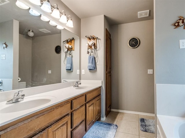 bathroom featuring double vanity, visible vents, a sink, and tile patterned floors