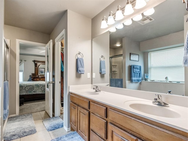 full bath featuring double vanity, visible vents, a sink, and ensuite bathroom