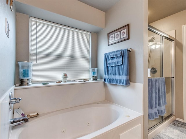 bathroom with a whirlpool tub and a shower stall