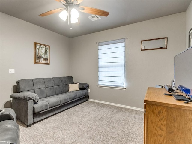 living area featuring light colored carpet, visible vents, ceiling fan, and baseboards