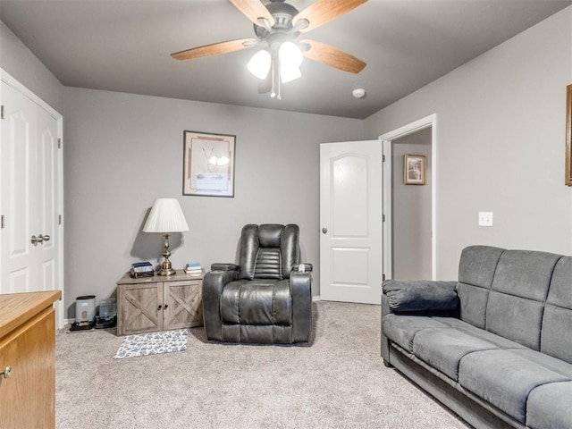 living area featuring carpet floors and a ceiling fan